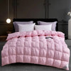 A pink quilted duvet with white pillows displayed on a dark bed against a gray wall.