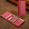 A red leather magnetic wallet phone case with card slots and a kickstand resting on a brown surface.