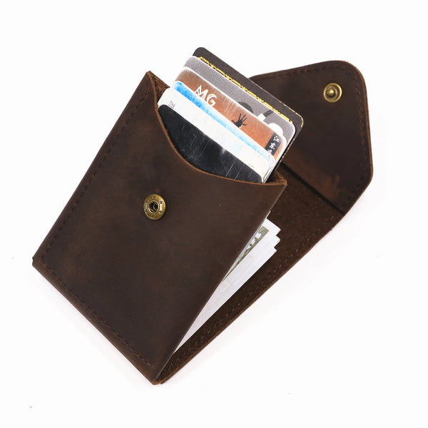 A brown full-grain leather wallet is shown open, displaying several cards and cash inside.