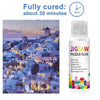 A bottle of Jigsaw Puzzle Glue for diamond painting, showing a fully cured product in a cityscape design.