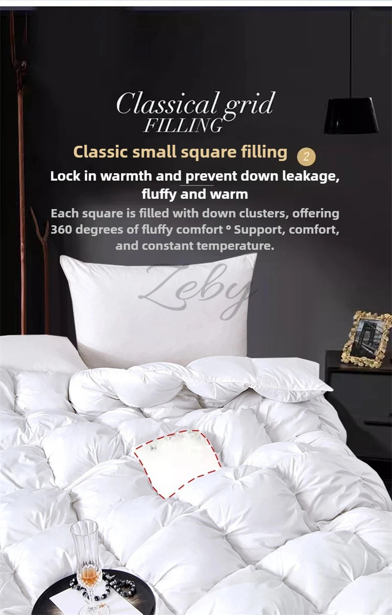 A white goose down comforter filled with a classic grid pattern, shown on a bed.