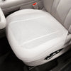 A white breathable leather car seat cushion is shown in a close-up view.