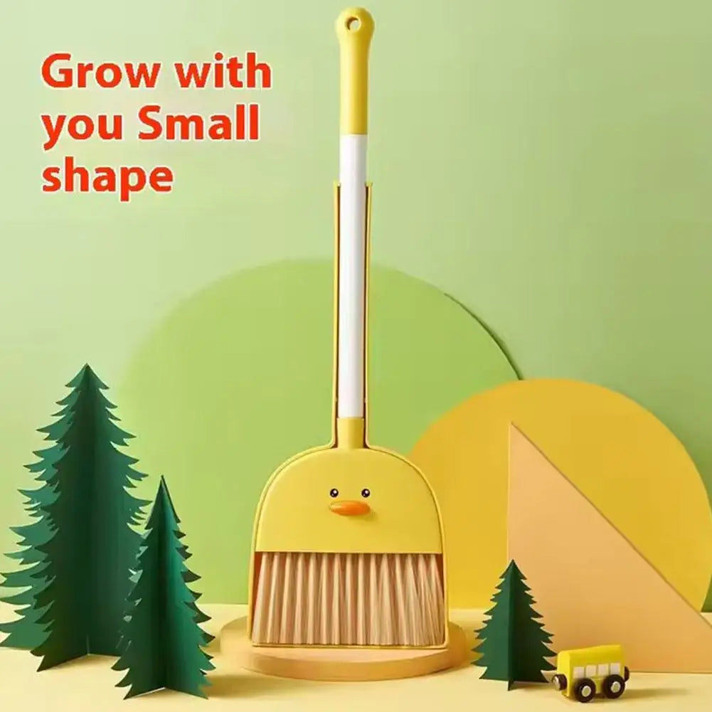 A yellow kids broom and dustpan set with an adjustable mop, set against a light green background with pine trees.