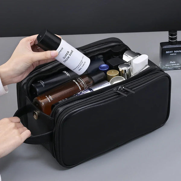 A black waterproof hanging toiletry bag is open, showing various beauty products and a perfume bottle.