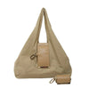A beige retractable keychain tote bag folded into a compact pouch with a leather strap and attached keychain.