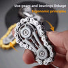 A hand holds a silver sprocket fidget spinner, demonstrating ergonomic principles for stress relief.