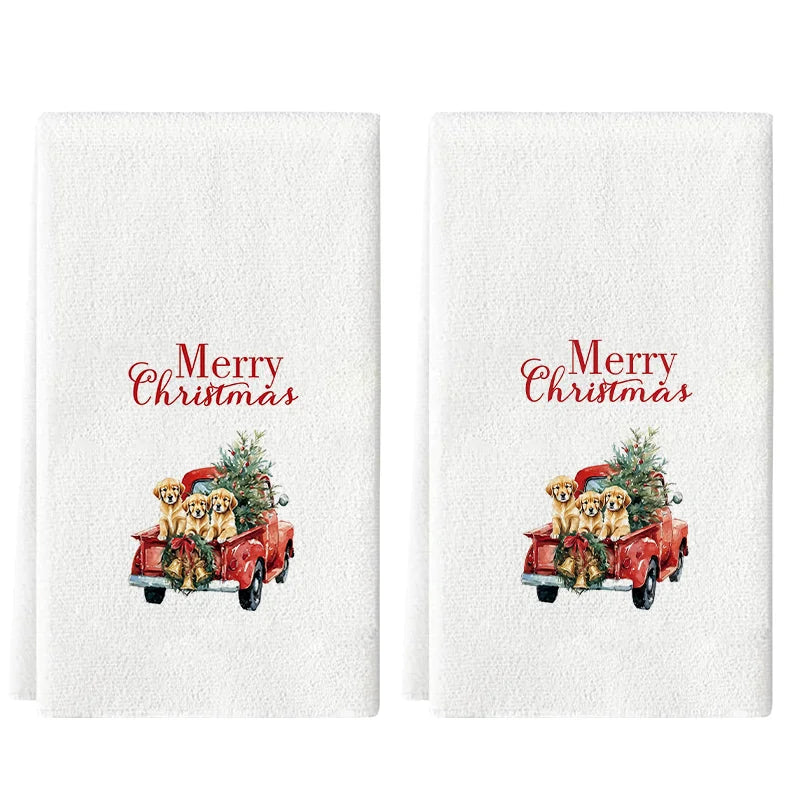 A set of white kitchen towels featuring a festive Christmas scene with a red pickup truck and golden dogs.