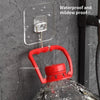 A red rotating wall hook is attached to a clear adhesive plate on a gray wall, used for storage.