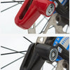 A close-up view of a red anti-theft disc brake lock for a motorcycle wheel.