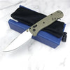 A folding pocket knife with a drop point blade is shown resting in a blue case with black lining.