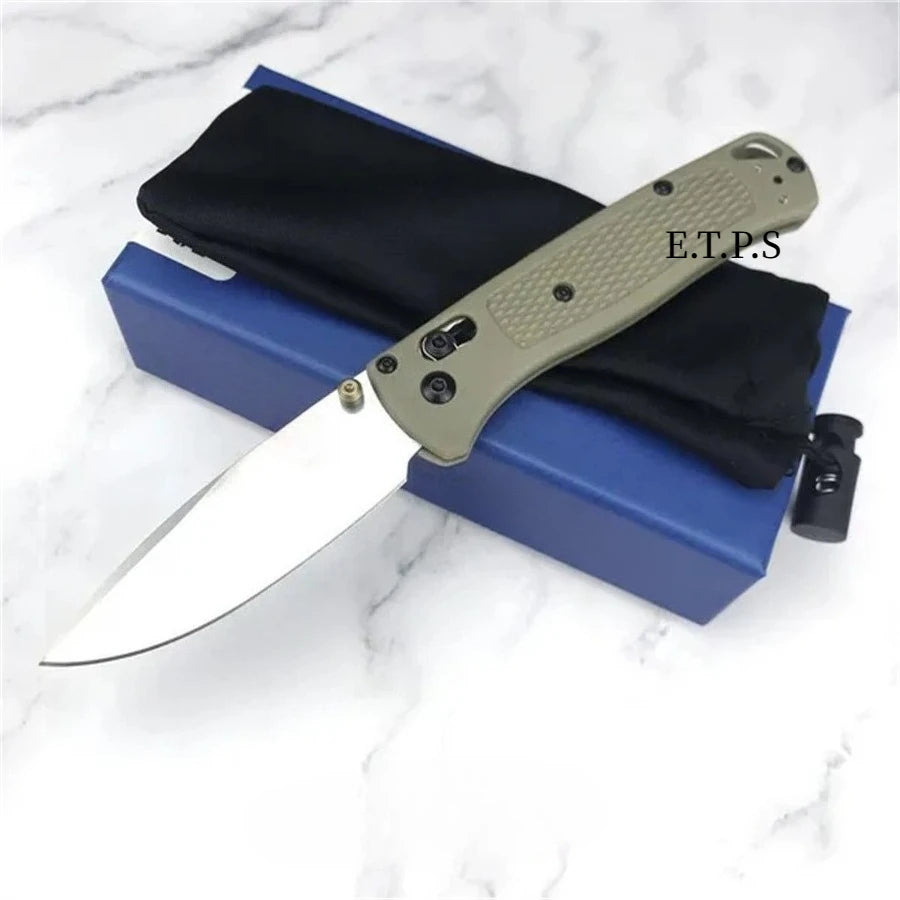 A folding pocket knife with a drop point blade is shown resting in a blue case with black lining.