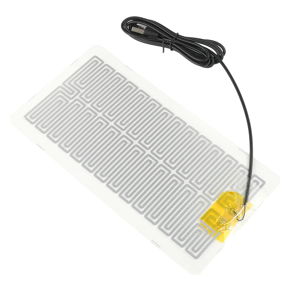 A clear heating pad with a grid pattern and a black cord is shown for desk or plant warmth.