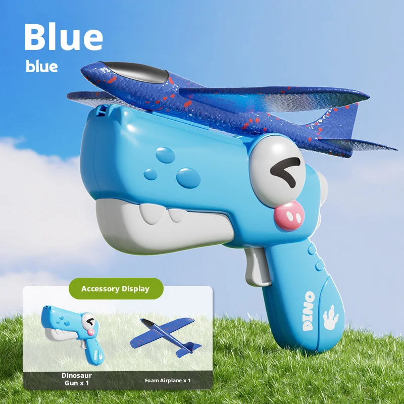 A blue dinosaur foam airplane launcher toy set with accessories displayed on green grass.
