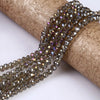 A strand of faceted crystal glass spacer beads in a warm brown tone is unwrapped on a rolled paper background.