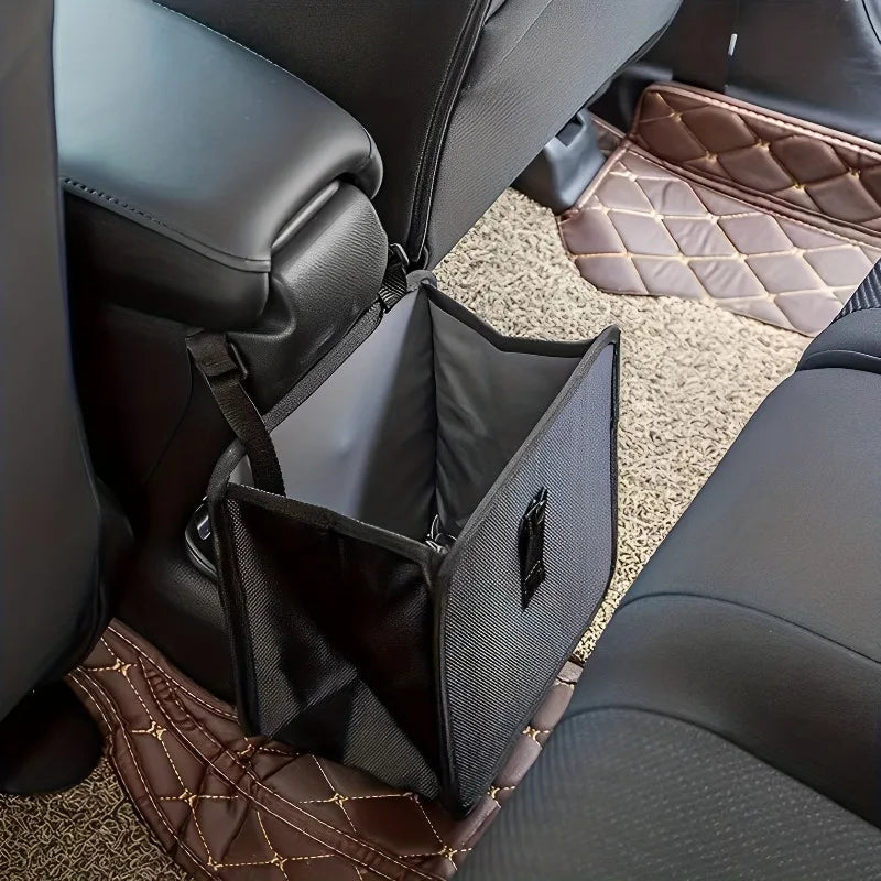 A black foldable car trash can and organizer with a waterproof liner is shown inside a dark car seat.