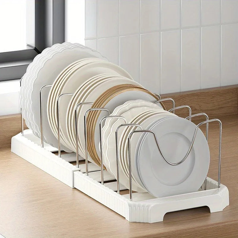 A white organizer rack holds a stack of round plates and bowls with adjustable dividers.