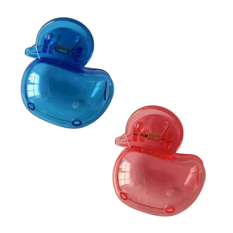A pair of clear blue and pink portable toothbrush head covers with clips.