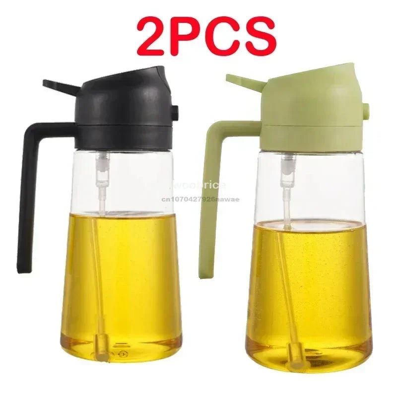 A pair of clear glass oil spray bottles with black and light green tops for cooking.