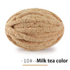 A ball of light brown chenille yarn labeled as Milk tea color for hand knitting
