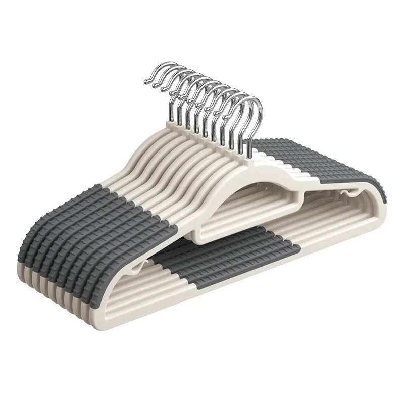 A plastic hanger with rotating hooks and a textured anti-slip base is shown.