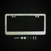 A rectangular crystal rhinestone license plate frame with mounting tabs and two screw caps is shown on a black background.