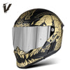 A black full-face motorcycle helmet featuring gold and black graphic designs with a silver visor.