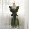 A green ruffled cotton linen kitchen apron with lace trim displayed on a mannequin.