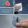 A hand cleans debris and touches a seal strip on a red resin disk to ensure proper sealing for windshield repair.