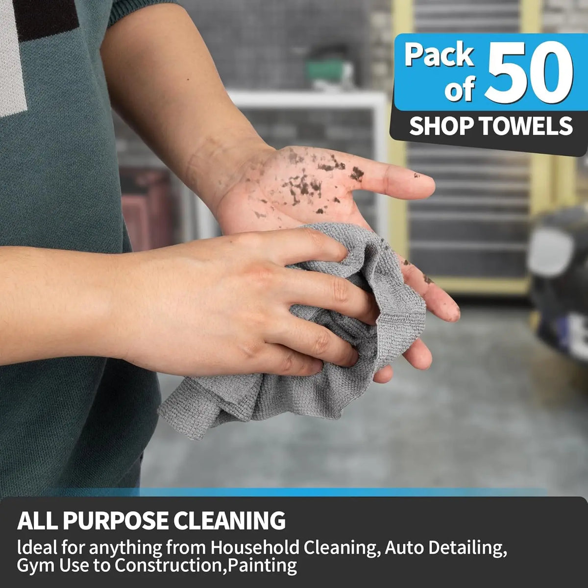 A hand is wiping a surface with a gray microfiber cleaning cloth, demonstrating the use of household cleaning towels.