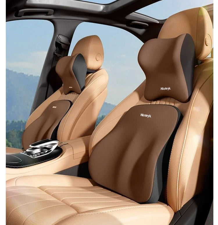 A tan memory foam car seat features a headrest and lumbar support cushion for comfort.