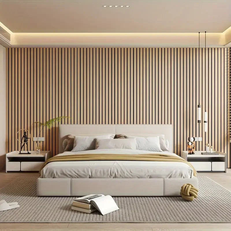 A modern bedroom featuring a white upholstered bed against a vertical wood slat wall with recessed lighting.