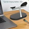 A magnetic wireless charging station for iPhone, Apple Watch, and AirPods resting on a wooden desk.