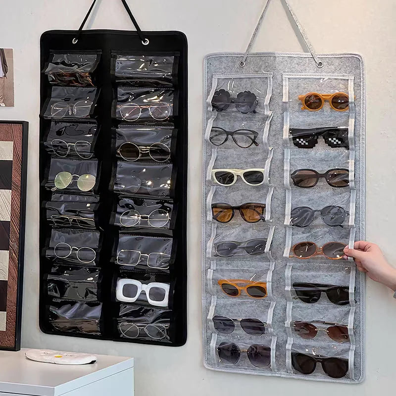 A black felt eyewear organizer with 16 slots is displayed on a white surface.
