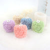 A collection of five pastel colored 3D rose pillar candle silicone molds for DIY candles and soap.