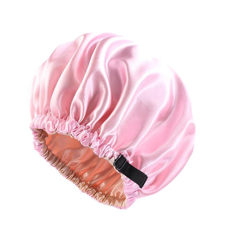 Pink satin sleep bonnet with elasticized trim and a black tie