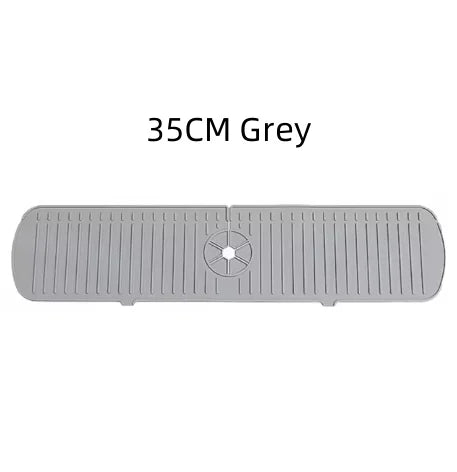 A grey silicone faucet drain mat with ridges and a central drain hole.