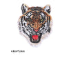 Embroidery patch of a tiger head featuring black, white, and orange fur details.