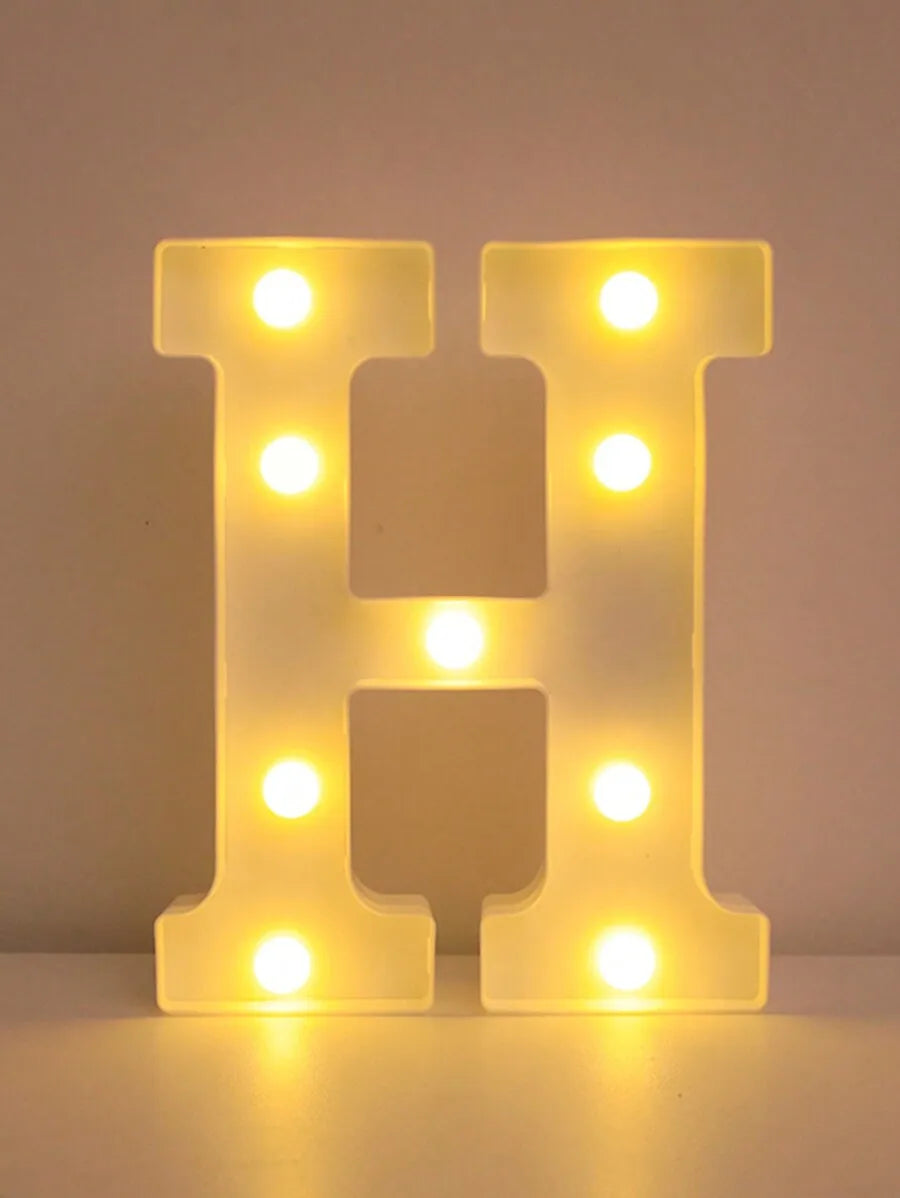 A glowing letter H made of LED lights used as a night light or party decor.