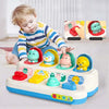 A baby is interacting with an interactive pop-up animal sensory toy featuring various colorful plastic animals.