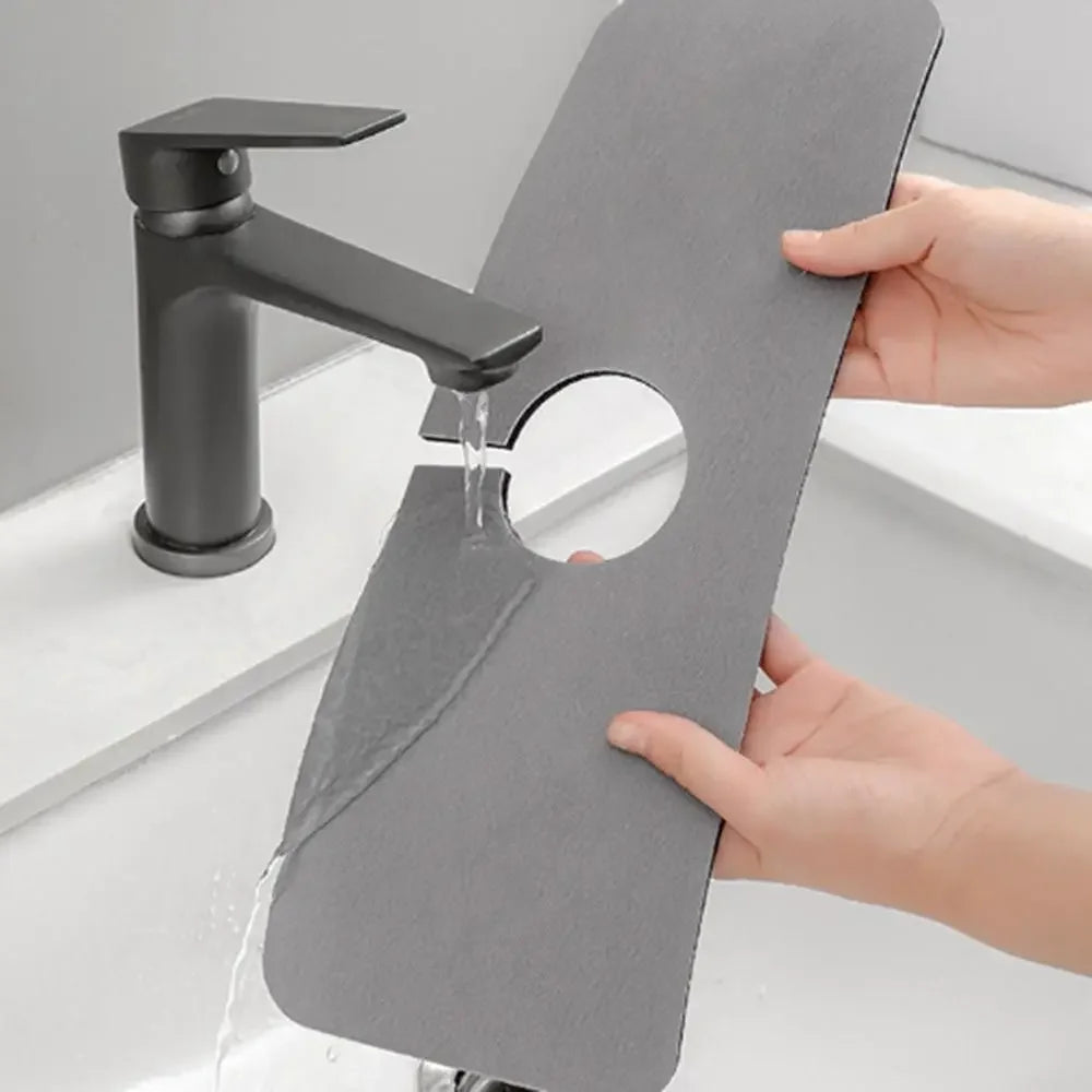 A black marble faucet drying mat is shown with a modern faucet dripping water onto the mat.