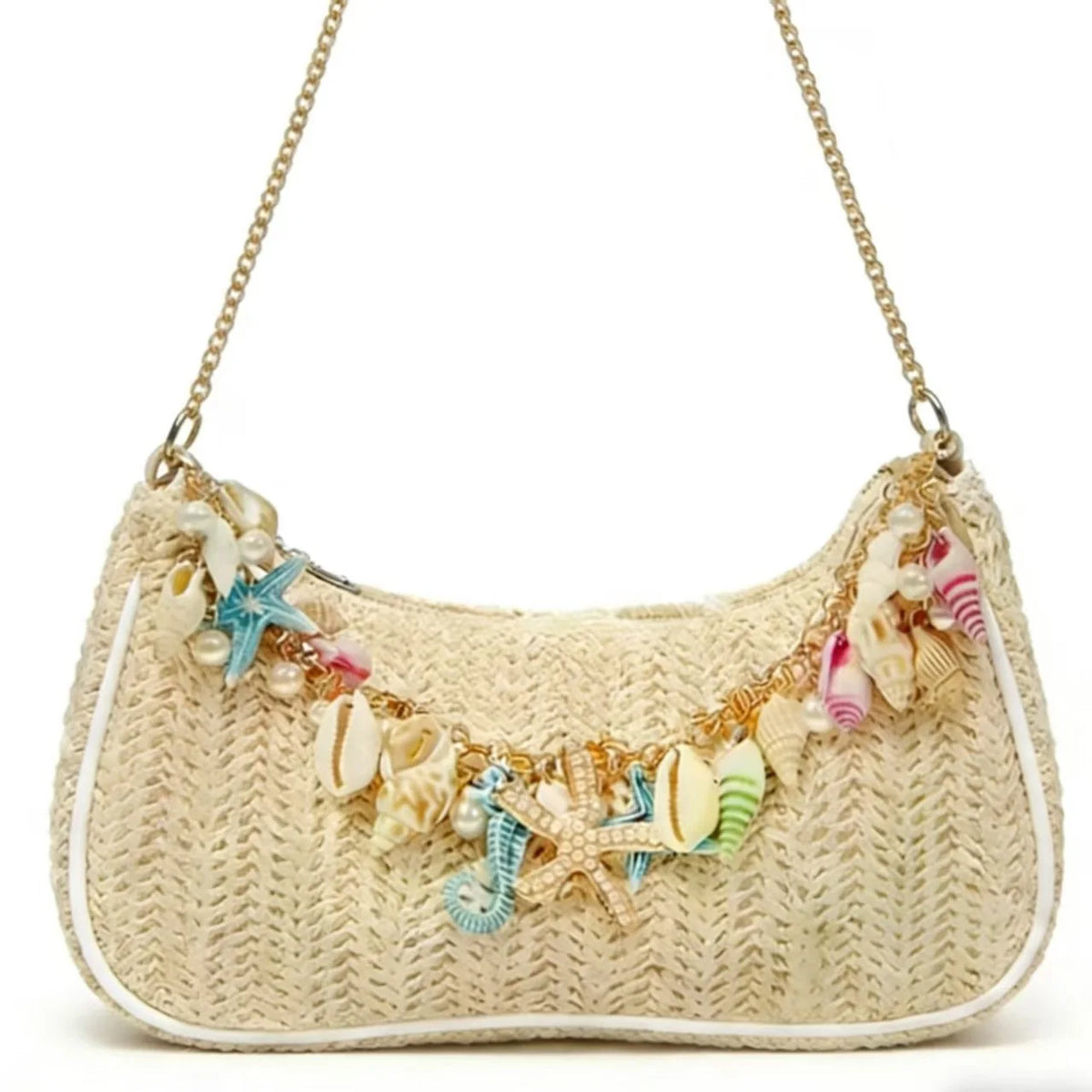 A beige straw shoulder bag adorned with colorful ocean shell charms and a gold chain.