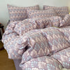 A set of soft printed duvet covers and pillowcases in a mauve and light blue floral pattern.