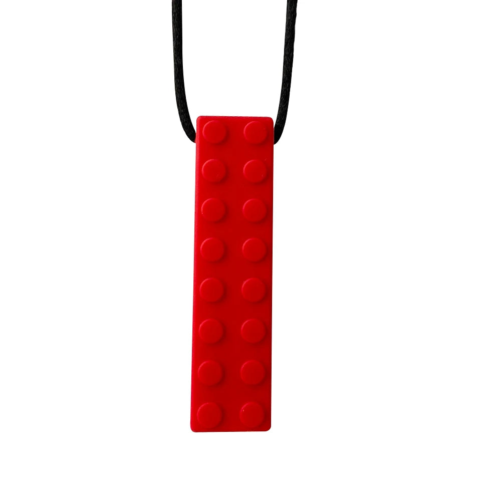 A red silicone sensory chew necklace pendant with a black cord.