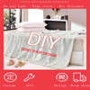 A gray flannel throw blanket with a vintage skull print is displayed on a bed.