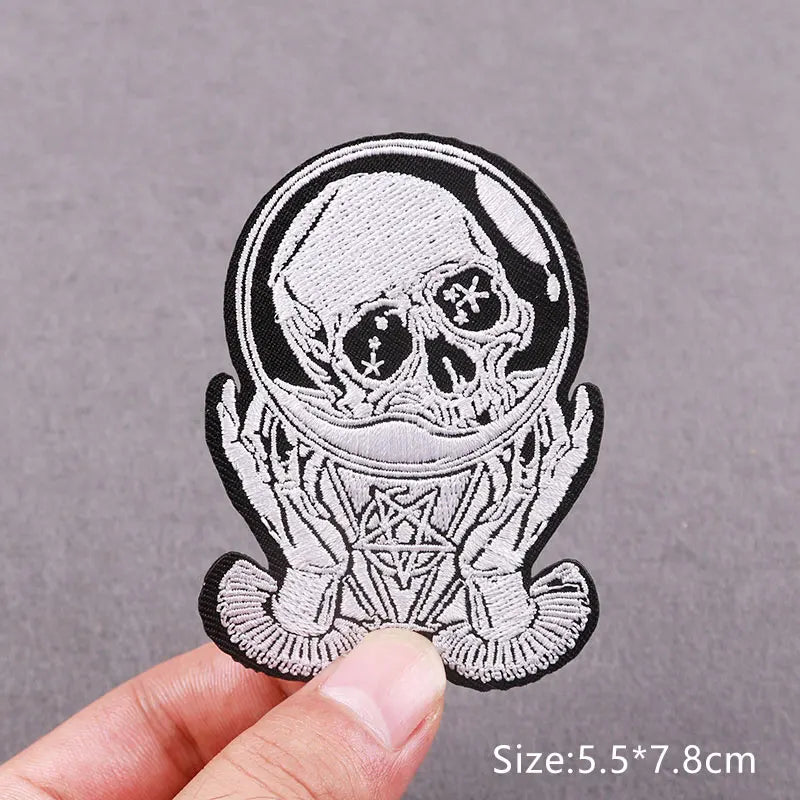 Black and white embroidered skull horror patch with intricate design on a gray background
