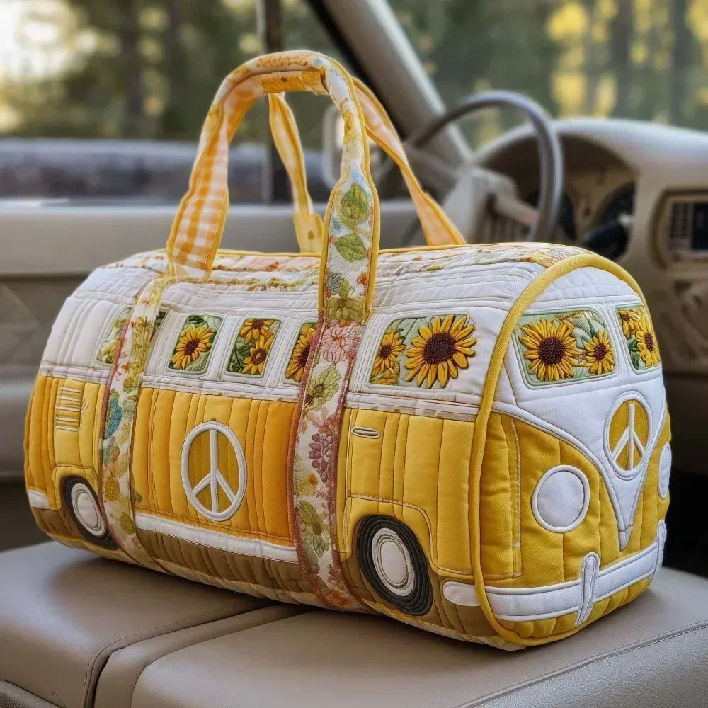 Yellow quilted travel duffle bag with sunflower and peace sign embroidery resting on a light-colored car seat.