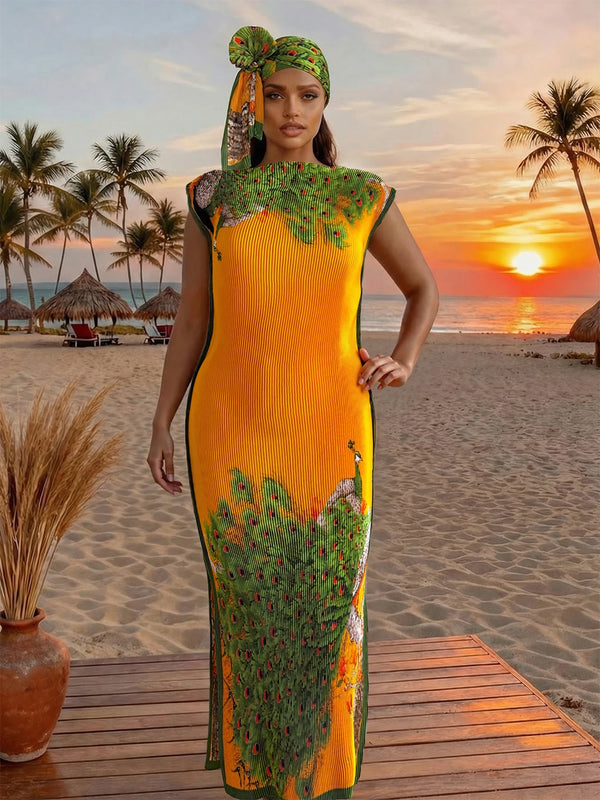 A model wearing an orange and green floral butterfly peacock print shawl stands on a wooden deck near a beach at sunset.