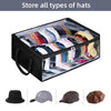 A black collapsible storage box filled with various types of hats, including fedoras and caps.