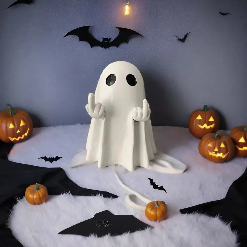 A white ghost resin statue with outstretched hands sits on a white fluffy surface against a dark background decorated with ba