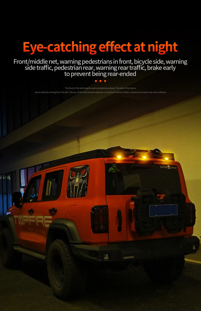 An orange Jeep-like vehicle with a custom front grille design and mounted strobe lights is shown.